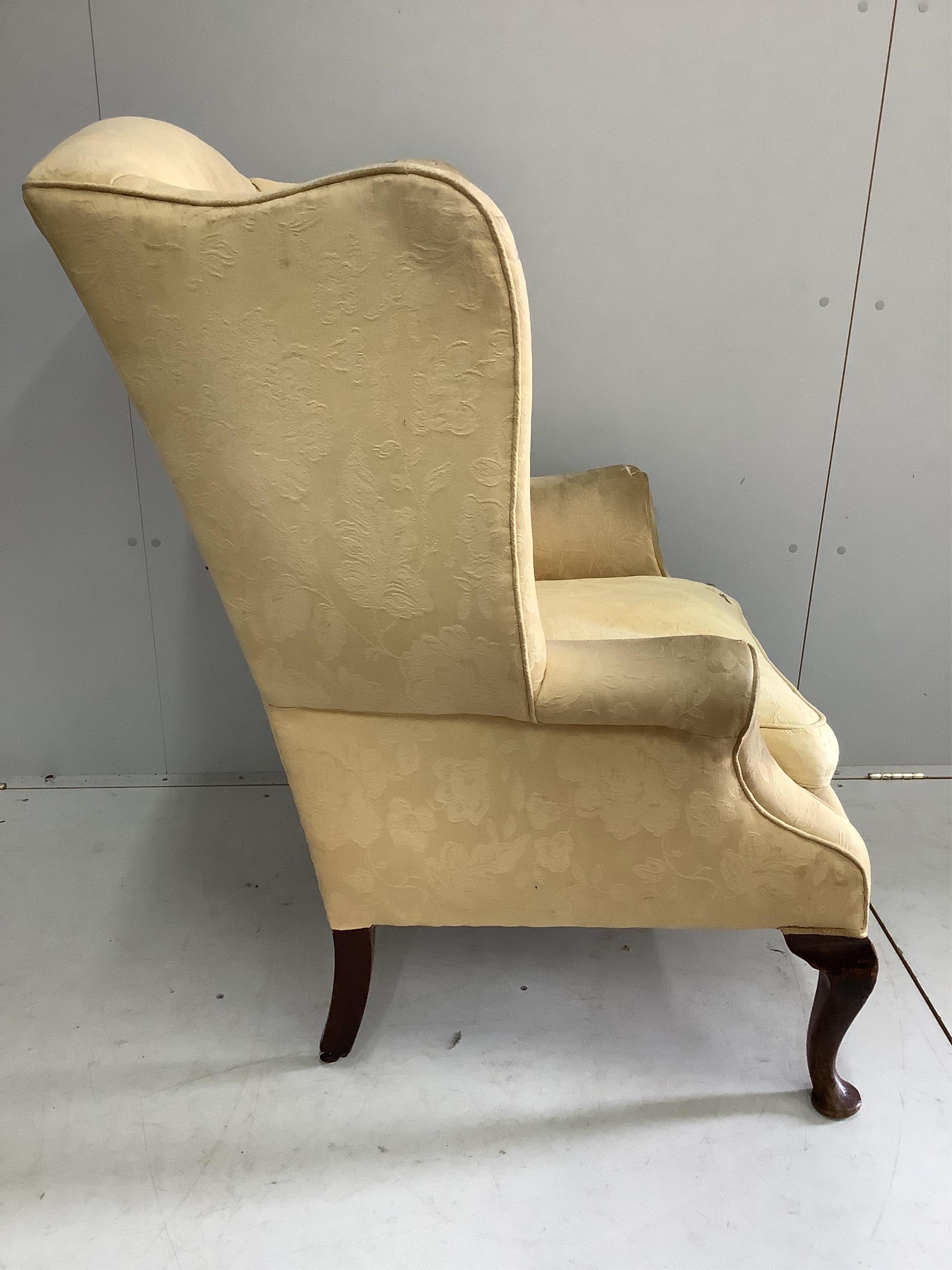 A George III upholstered wing armchair, width 86cm, depth 74cm, height 105cm. Condition - poor to fair